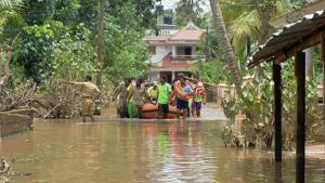Kerala and Tamil Nadu fire force personnel transport children and elderly people in a dinghy through flood waters during a rescue operation in Annamanada village of Kerala.(AFP Photo) Kerala and Tamil Nadu fire force personnel transport children and elderly people in a dinghy through flood waters during a rescue operation in Annamanada village of Kerala.(AFP Photo)