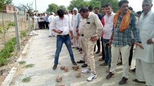 Cops inspecting the crime spot in Bhiwani on Monday where two motorcycle-borne robbers gunned down the manager of the Bhiwani Cooperative Bank.(Manoj Dhaka/HT) Cops inspecting the crime spot in Bhiwani on Monday where two motorcycle-borne robbers gunned down the manager of the Bhiwani Cooperative Bank.(Manoj Dhaka/HT)