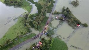 An aerial view shows partially submerged road at a flooded area in the southern state of Kerala on August 19.(REUTERS) An aerial view shows partially submerged road at a flooded area in the southern state of Kerala on August 19.(REUTERS)