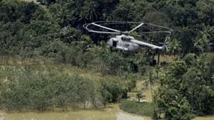 An Indian Air Force helicopter on rescue mission flies through a flooded area in Chengannur in Kerala on Sunday.(AP photo) An Indian Air Force helicopter on rescue mission flies through a flooded area in Chengannur in Kerala on Sunday.(AP photo)