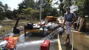 A resident cleans household goods salvaged from sludge in his flood affected house on the outskirts of Kochi on August 21.(AP Photo) A resident cleans household goods salvaged from sludge in his flood affected house on the outskirts of Kochi on August 21.(AP Photo)