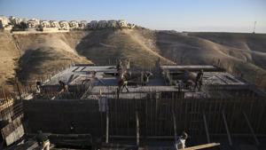 FILE - In this Feb. 7, 2017 file photo, Palestinian laborers work at a construction site in the Israeli settlement of Maale Adumim, near Jerusalem. Wm(AP) FILE - In this Feb. 7, 2017 file photo, Palestinian laborers work at a construction site in the Israeli settlement of Maale Adumim, near Jerusalem. Wm(AP)