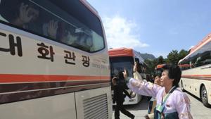 North Koreans wave to their South Korean relatives on a bus to bid farewell after the separated family reunion meeting at the Diamond Mountain resort in North Korea on Wednesday.(AP Photo) North Koreans wave to their South Korean relatives on a bus to bid farewell after the separated family reunion meeting at the Diamond Mountain resort in North Korea on Wednesday.(AP Photo)