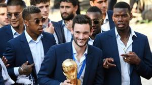France's goalkeeper Hugo Lloris holds the World Cup trophy next to France's midfielder Paul Pogba (right) as they arrive for a reception at the Elysee Presidential Palace on July 16.(AFP) France's goalkeeper Hugo Lloris holds the World Cup trophy next to France's midfielder Paul Pogba (right) as they arrive for a reception at the Elysee Presidential Palace on July 16.(AFP)