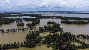 Trees and houses are partially submerged in floodwaters in this aerial photograph taken in Kainakary village in the district of Alappuzha in Kerala on August 23.(Bloomberg) Trees and houses are partially submerged in floodwaters in this aerial photograph taken in Kainakary village in the district of Alappuzha in Kerala on August 23.(Bloomberg)