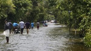 People wade across a waterlogged street in a flood-affected area, in Alleppey on August 26.(PTI Photo) People wade across a waterlogged street in a flood-affected area, in Alleppey on August 26.(PTI Photo)