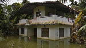 A man wades through water after arriving to inspect his flood affected house in Kuttanad, Alappuzha in Kerala on August 27.(AP Photo) A man wades through water after arriving to inspect his flood affected house in Kuttanad, Alappuzha in Kerala on August 27.(AP Photo)