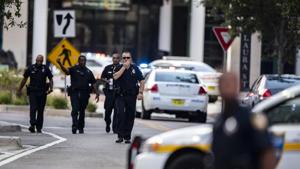 Police gather after a shooter was reported at the Jacksonville Landing in Jacksonville, Florida on Sunday.(AP) Police gather after a shooter was reported at the Jacksonville Landing in Jacksonville, Florida on Sunday.(AP)