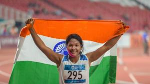 Indian athlete Swapna Barman celebrates after winning the gold medal in the women's Heptathlon event at the 18th Asian Games.(PTI)