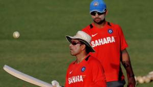 Indian cricketer Sachin Tendulkar tosses the ball as teammate Virat Kohli(R) looks on during a training session at The Punjab Cricket Associaton (PCA) Stadium in Mohali on March 27, 2011.(AFP/Getty Images) Indian cricketer Sachin Tendulkar tosses the ball as teammate Virat Kohli(R) looks on during a training session at The Punjab Cricket Associaton (PCA) Stadium in Mohali on March 27, 2011.(AFP/Getty Images)