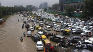 Traffic congestion due to waterlogging after heavy rains at Sector 10 in Gurugram on Tuesday.(Yogendra Kumar/HT PHOTO)