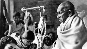 Mahatma Gandhi, wrapped in his white shawl, sits before a microphone to speak at a prayer meeting in New Delhi. It was the second day of Gandhi’s fast (January 14, 1948) for communal peace. He ended his fast on January 18 after being given a pledge of harmony by leaders of different communities.(AP Photo) Mahatma Gandhi, wrapped in his white shawl, sits before a microphone to speak at a prayer meeting in New Delhi. It was the second day of Gandhi’s fast (January 14, 1948) for communal peace. He ended his fast on January 18 after being given a pledge of harmony by leaders of different communities.(AP Photo)