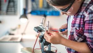 Young girl fixing a robot arm in a workshop.(Getty Images) Young girl fixing a robot arm in a workshop.(Getty Images)