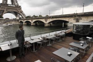 A waiter stands at French chef Alain Ducasse's new boat restaurant, the Ducasse sur Seine.(AFP) A waiter stands at French chef Alain Ducasse's new boat restaurant, the Ducasse sur Seine.(AFP)