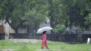 Children walk in the rain under in Noida on Sunday. Heavy rains lashed parts of northern India over the weekend.(Sunil Ghosh/HT Photo) Children walk in the rain under in Noida on Sunday. Heavy rains lashed parts of northern India over the weekend.(Sunil Ghosh/HT Photo)