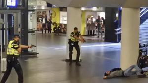 Dutch police officers point their guns at a wounded 19-year-old man who was shot by police after stabbing two people in the central railway station in Amsterdam on August 31, 2018.(AP Photo) Dutch police officers point their guns at a wounded 19-year-old man who was shot by police after stabbing two people in the central railway station in Amsterdam on August 31, 2018.(AP Photo)