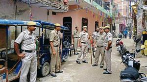 Police stand outside the house where the deceased lived with his uncles and elder brother.(HT Photo) Police stand outside the house where the deceased lived with his uncles and elder brother.(HT Photo)
