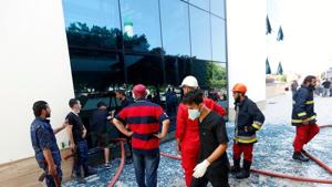 Firefighters and security personnel are seen at the headquarters of Libyan state oil firm National Oil Corporation (NOC) after three masked persons attacked it in Tripoli.(REUTERS) Firefighters and security personnel are seen at the headquarters of Libyan state oil firm National Oil Corporation (NOC) after three masked persons attacked it in Tripoli.(REUTERS)