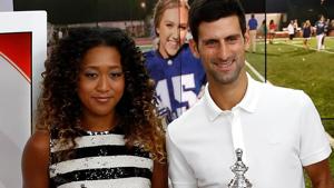 Novak Djokovic of Serbia and Naomi Osaka of Japan hold their winners trophies.(AFP) Novak Djokovic of Serbia and Naomi Osaka of Japan hold their winners trophies.(AFP)