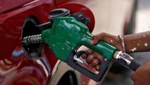 A worker holds a nozzle to pump petrol into a vehicle at a fuel station in Mumbai.(Reuters File Photo) A worker holds a nozzle to pump petrol into a vehicle at a fuel station in Mumbai.(Reuters File Photo)