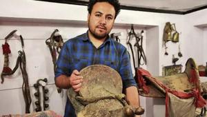 Munshi Aziz Bhat’s great grandson Muzammil Hussain holds an antique horse saddle, Kargil, Jammu and Kashmir.(Waseem Andrabi/HT Photo) Munshi Aziz Bhat’s great grandson Muzammil Hussain holds an antique horse saddle, Kargil, Jammu and Kashmir.(Waseem Andrabi/HT Photo)