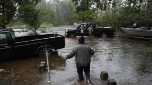 A resident walks from her flooded house towards the crew of the Cajun Navy in Lumberton, North Carolina, on September 15, 2018 in the wake of Hurricane Florence.(AFP) A resident walks from her flooded house towards the crew of the Cajun Navy in Lumberton, North Carolina, on September 15, 2018 in the wake of Hurricane Florence.(AFP)