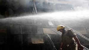 A firefighter walks as others try to douse a fire that broke out at a wholesale market in Kolkata, India, September 16, 2018.(REUTERS Representative Photo) A firefighter walks as others try to douse a fire that broke out at a wholesale market in Kolkata, India, September 16, 2018.(REUTERS Representative Photo)