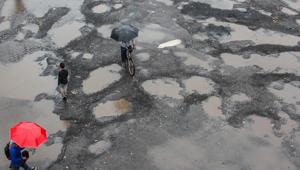Commuters walks past potholes at Bandra Station bus stop in Mumbai.(Prabhat Mehrotra/HT File photo) Commuters walks past potholes at Bandra Station bus stop in Mumbai.(Prabhat Mehrotra/HT File photo)