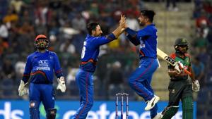 Afghan cricketer Rashid Khan (2R) celebrates with teammate Rahmat Shah (2L) and wicketkeeper Mohammad Shahzad (L) after he dismissed Bangladesh batsman Mehidy Hasan Miraz.(AFP) Afghan cricketer Rashid Khan (2R) celebrates with teammate Rahmat Shah (2L) and wicketkeeper Mohammad Shahzad (L) after he dismissed Bangladesh batsman Mehidy Hasan Miraz.(AFP)