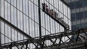 A sign sits on the glass wall of financial ratings agency Fitch Ratings in the Canary Wharf business district in London.(Bloomberg) A sign sits on the glass wall of financial ratings agency Fitch Ratings in the Canary Wharf business district in London.(Bloomberg)