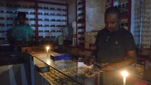 A shopkeeper doing business in candle light in Dhanbad on Wednesday evening, September 21,2018.(Bijay / HT Photo)