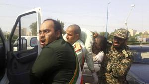 In this photo provided by the Iranian Students' News Agency, ISNA, Revolutionary Guard members carry a wounded comrade after a shooting during their parade marking the 38th anniversary of Iraq's 1980 invasion of Iran, in the southwestern city of Ahvaz, Iran, Saturday, Sept. 22, 2018.(AP) In this photo provided by the Iranian Students' News Agency, ISNA, Revolutionary Guard members carry a wounded comrade after a shooting during their parade marking the 38th anniversary of Iraq's 1980 invasion of Iran, in the southwestern city of Ahvaz, Iran, Saturday, Sept. 22, 2018.(AP)