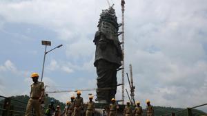 Policemen walk past the under construction ‘Statue of Unity’ portraying Sardar Vallabhbhai Patel, one of the founding fathers of India, during a media tour in Kevadiya in Gujarat.(Reuters Photo) Policemen walk past the under construction ‘Statue of Unity’ portraying Sardar Vallabhbhai Patel, one of the founding fathers of India, during a media tour in Kevadiya in Gujarat.(Reuters Photo)