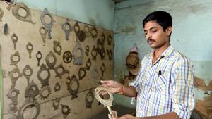 A man shows a Aranmula metal mirror at a workshop in Pathanamthitta district of Kerala. The traditional mirror craft is under threat of being wiped, say artists.(Vivek Nair/ HT Photo) A man shows a Aranmula metal mirror at a workshop in Pathanamthitta district of Kerala. The traditional mirror craft is under threat of being wiped, say artists.(Vivek Nair/ HT Photo)