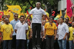 Ibrahim Mohamed Solih, centre, jumps as he walks in a street march with supporters in Male, September 22(AP) Ibrahim Mohamed Solih, centre, jumps as he walks in a street march with supporters in Male, September 22(AP)