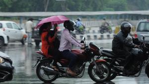 Commuters protect themselves from rain using umbrellas and raincoats at Rajiv Chowk, in Gurugram, India, on Monday, September 24, 2018.(HT Photo) Commuters protect themselves from rain using umbrellas and raincoats at Rajiv Chowk, in Gurugram, India, on Monday, September 24, 2018.(HT Photo)