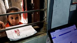 A girl waits for her turn to enrol for the Unique Identification database system, also known as Aadhaar, at a registration centre in New Delhi.(REUTERS File)