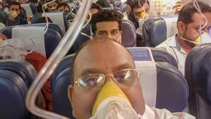 Passengers on board the Mumbai-Jaipur Jet Airways flight wear oxygen masks during an emergency after cabin pressure drop, in Mumbai, September 20(PTI) Passengers on board the Mumbai-Jaipur Jet Airways flight wear oxygen masks during an emergency after cabin pressure drop, in Mumbai, September 20(PTI)