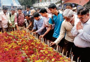 Commuters and relatives pay homage to victims who died in the stampede at Elphinstone Station last year on 29 Sept .(HT Photo)