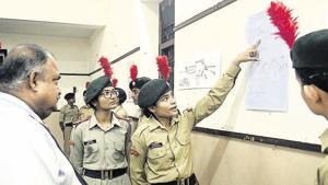 NCC cadets explaining the charts on the surgical strikes at an exhibition at Fergusson college on Saturday.(RAVINDRA JOSHI/HT PHOTO)