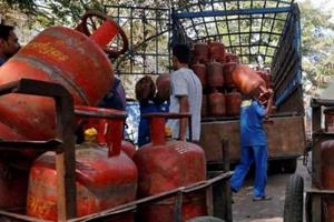 Workers load liquefied petroleum gas (LPG) cooking cylinders onto a supply truck. Image for representation.(Reuters file photo) Workers load liquefied petroleum gas (LPG) cooking cylinders onto a supply truck. Image for representation.(Reuters file photo)