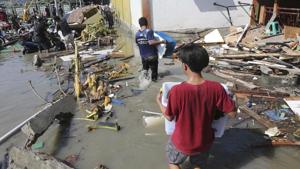 People carry items from a shopping mall badly damaged by a massive earthquake and tsunami in Palu, Central Sulawesi, Indonesia, Sunday, Sept. 30, 2018. Indonesia’s Sumba island was struck by two earthquakes in quick succession on October 2, 2018.(AP) People carry items from a shopping mall badly damaged by a massive earthquake and tsunami in Palu, Central Sulawesi, Indonesia, Sunday, Sept. 30, 2018. Indonesia’s Sumba island was struck by two earthquakes in quick succession on October 2, 2018.(AP)
