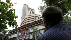 A man looks at a screen across a road displaying the Sensex on the facade of the Bombay Stock Exchange (BSE) building in Mumbai, India, June 29, 2015.(Reuters File Photo) A man looks at a screen across a road displaying the Sensex on the facade of the Bombay Stock Exchange (BSE) building in Mumbai, India, June 29, 2015.(Reuters File Photo)