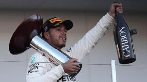 Lewis Hamilton celebrates on the podium after his victory in the Formula One Japanese Grand Prix at Suzuka.(AFP) Lewis Hamilton celebrates on the podium after his victory in the Formula One Japanese Grand Prix at Suzuka.(AFP)