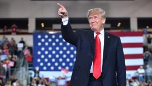 US President Donald Trump arrives to speak during a US President Donald Trump arrives to speak during a