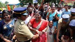 A woman reacts as she is detained by a police officer during a protest called by various Hindu organisations against the lifting of ban by Supreme Court that allowed entry of women of menstruating age to the Sabarimala temple, in Kochi, October 10(REUTERS) A woman reacts as she is detained by a police officer during a protest called by various Hindu organisations against the lifting of ban by Supreme Court that allowed entry of women of menstruating age to the Sabarimala temple, in Kochi, October 10(REUTERS)