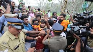 Police personnel tackling devotees protesting against the entry of women of all ages to the Sabarimala temple, at Nilakkal base camp in Pathanam, Kerala, on Tuesday.(Vivek Nair/HT Photo) Police personnel tackling devotees protesting against the entry of women of all ages to the Sabarimala temple, at Nilakkal base camp in Pathanam, Kerala, on Tuesday.(Vivek Nair/HT Photo)