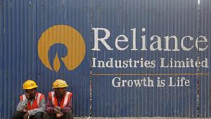 Labourers rest in front of an advertisement of Reliance Industries Limited at a construction site in Mumbai, India, March 2, 2016.(Reuters File Photo) Labourers rest in front of an advertisement of Reliance Industries Limited at a construction site in Mumbai, India, March 2, 2016.(Reuters File Photo)