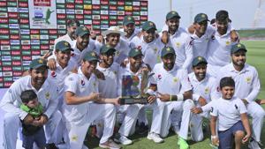 Pakistan's players hold the trophy after they beat Australia in their test match in Abu Dhabi, United Arab Emirates.(AP) Pakistan's players hold the trophy after they beat Australia in their test match in Abu Dhabi, United Arab Emirates.(AP)