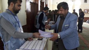 An Afghan man receives a ballot paper at a polling station during Parliamentary elections in Kabul.(AP Photo) An Afghan man receives a ballot paper at a polling station during Parliamentary elections in Kabul.(AP Photo)